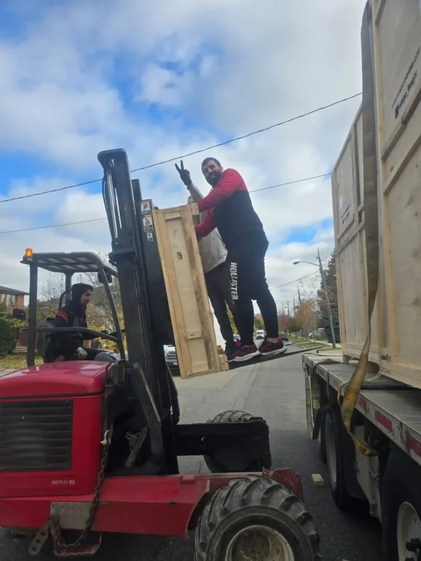 Heavy wooden crates being loaded with a forklift during a professional moving service in Mississauga