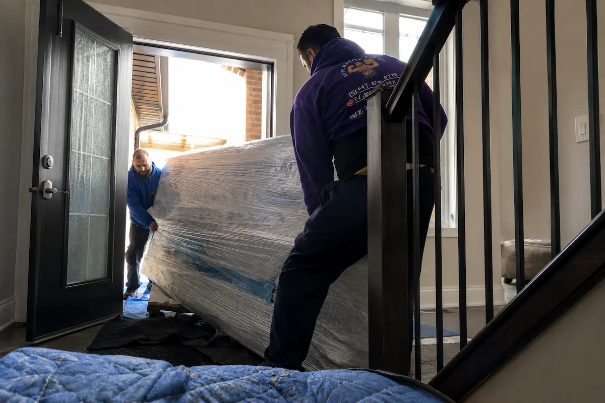 Residential movers carrying furniture during a home move in Mississauga