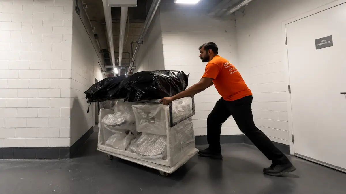 Wrapped furniture being transported through a condo service corridor in North York